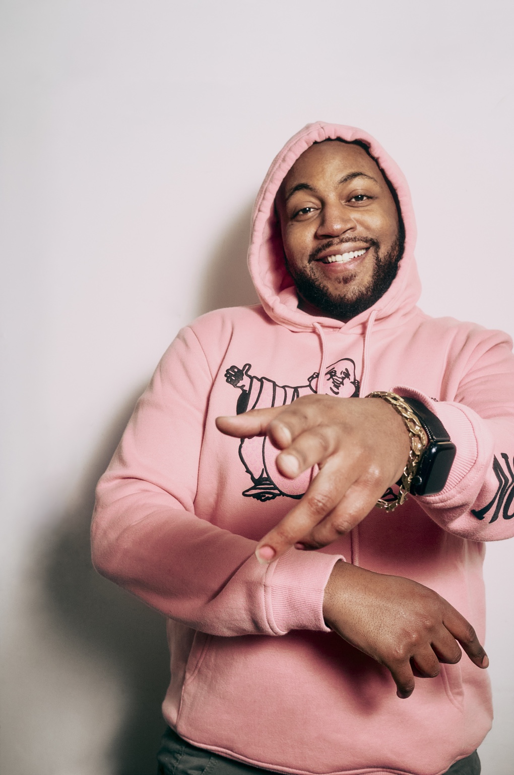 Master S BTB smiling in a pink hoodie